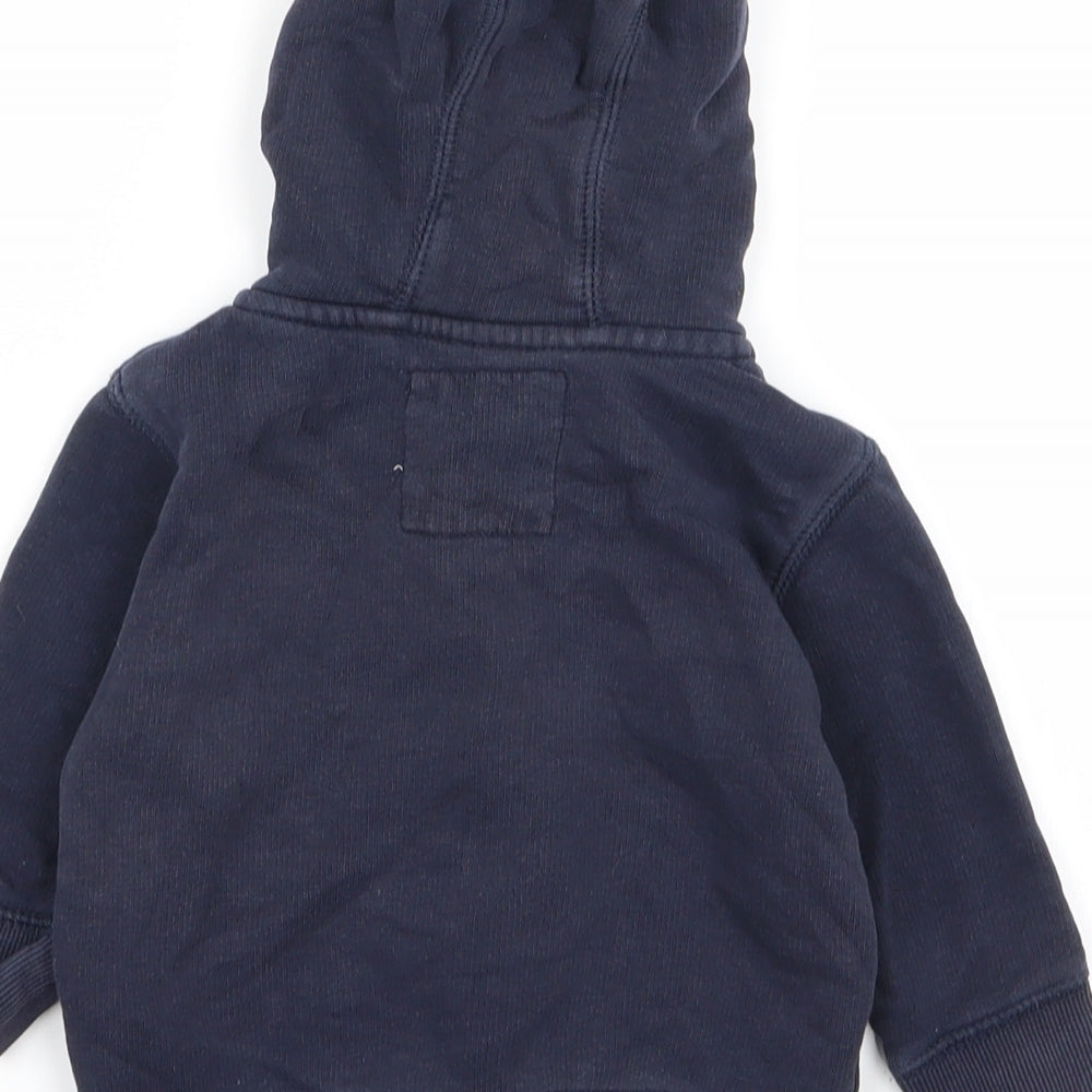 Brand and care label for Next boys’ blue full zip jumper, size 6-9, months