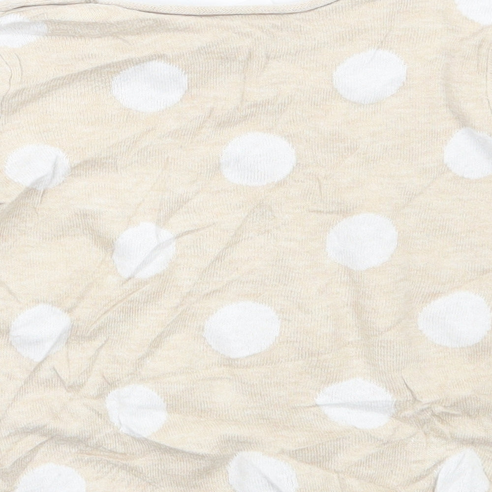 Brand and care label for H&M girls’ beige polka dot jumper, size 9-12, months