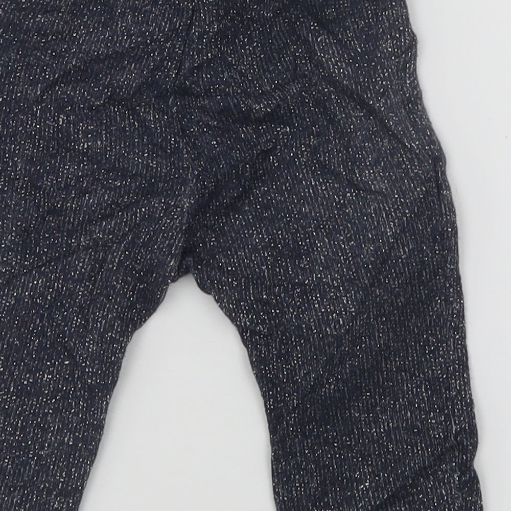 Brand and care label for United Colors of Benetton girls’ blue sweatpants, size 6-9, months