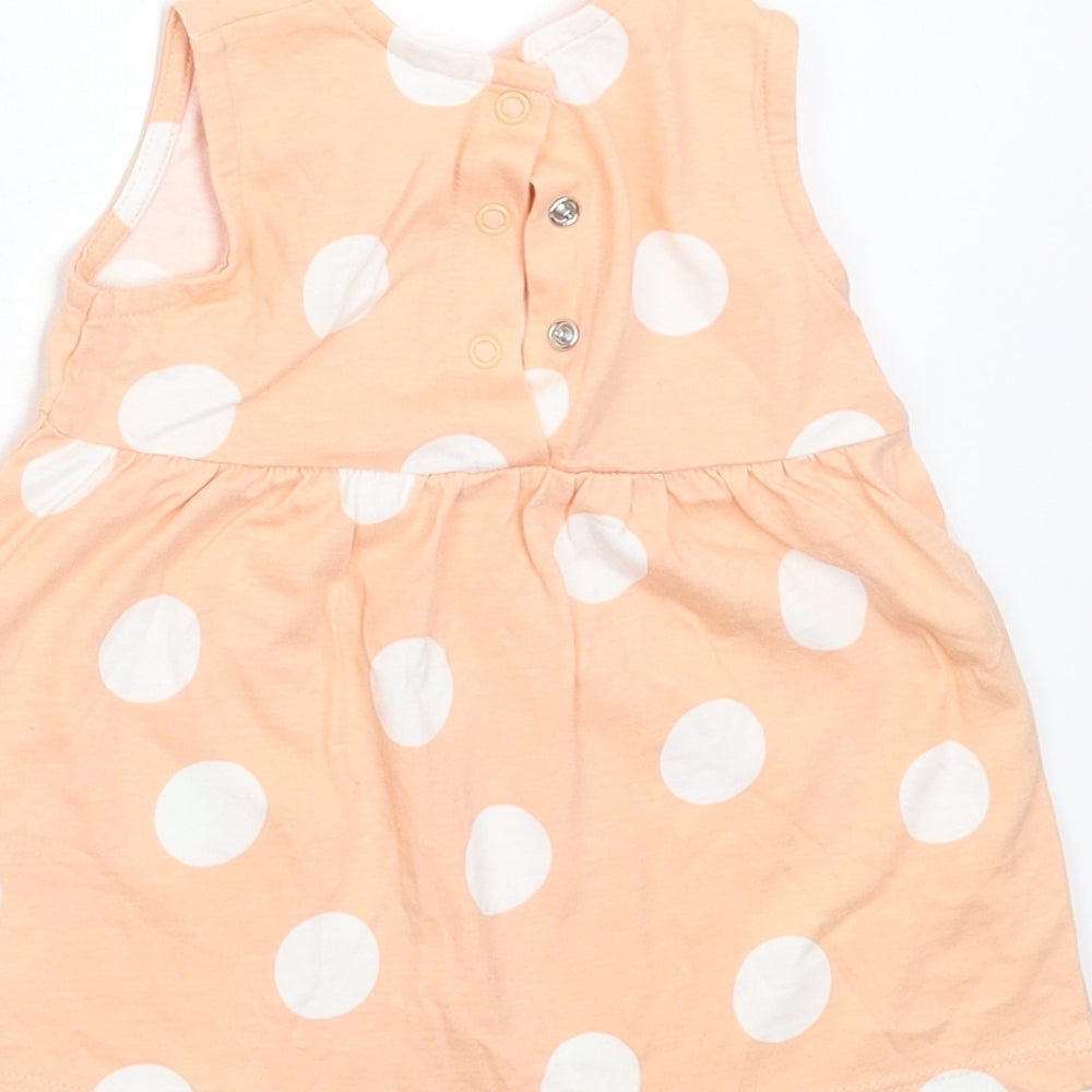 Brand and care label for George girls’ orange polka dot t-shirt dress, size 0-3, months