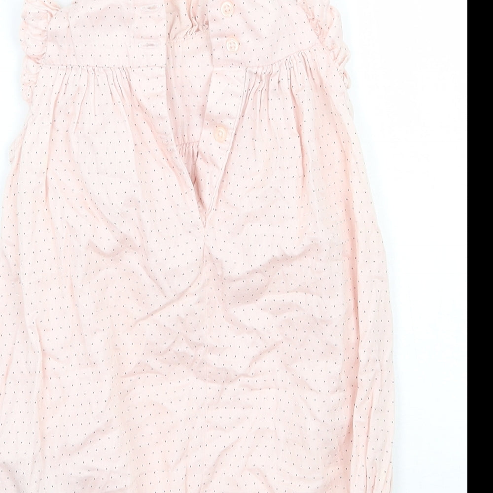 Brand and care label for Baby Gap girls’ pink babygrow one-piece, size 3-6, months