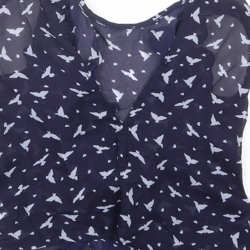 Brand and care label for Tu girls’ blue geometric basic blouse, size 5, years