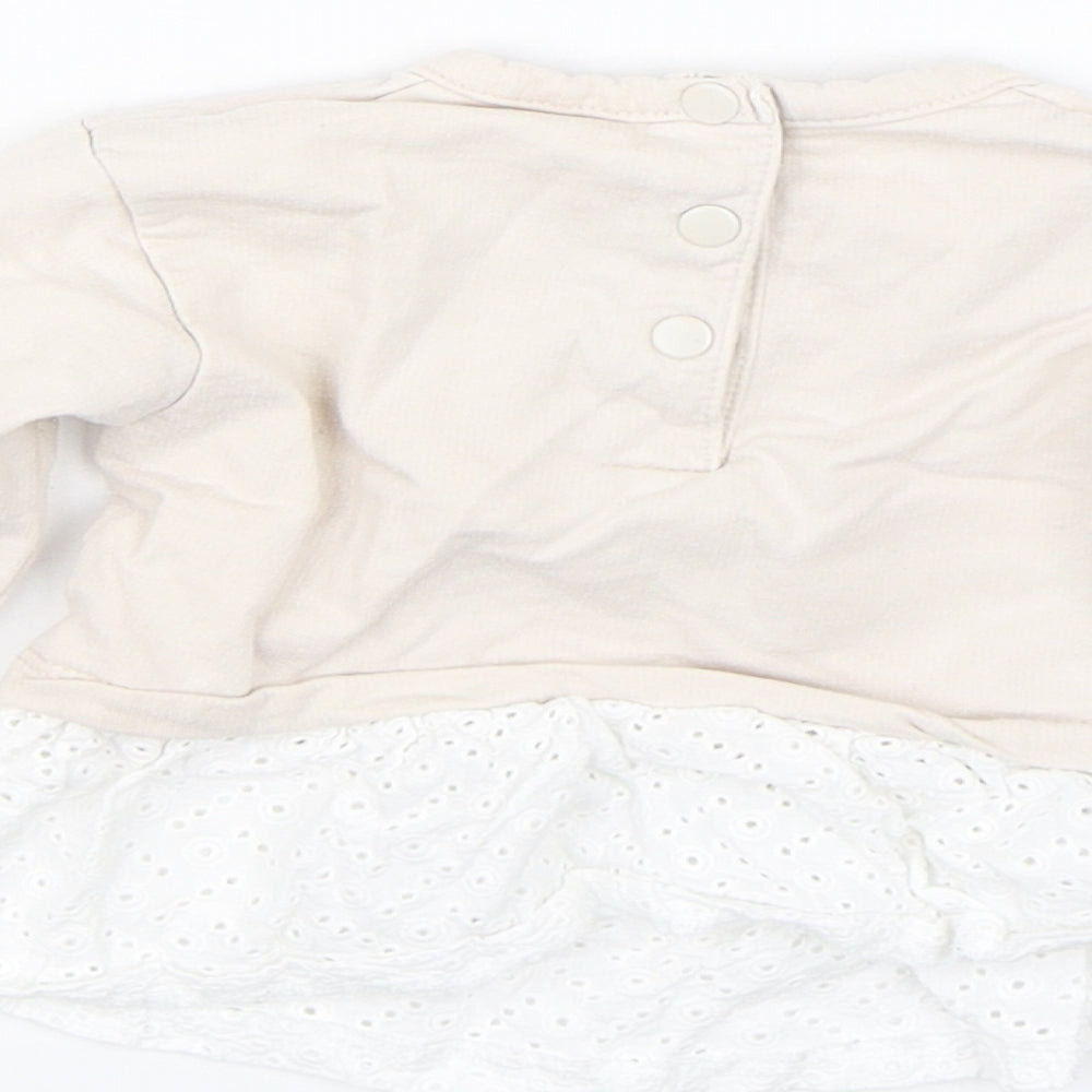 Brand and care label for Prenatal girls’ beige jumper, size 3-6, months