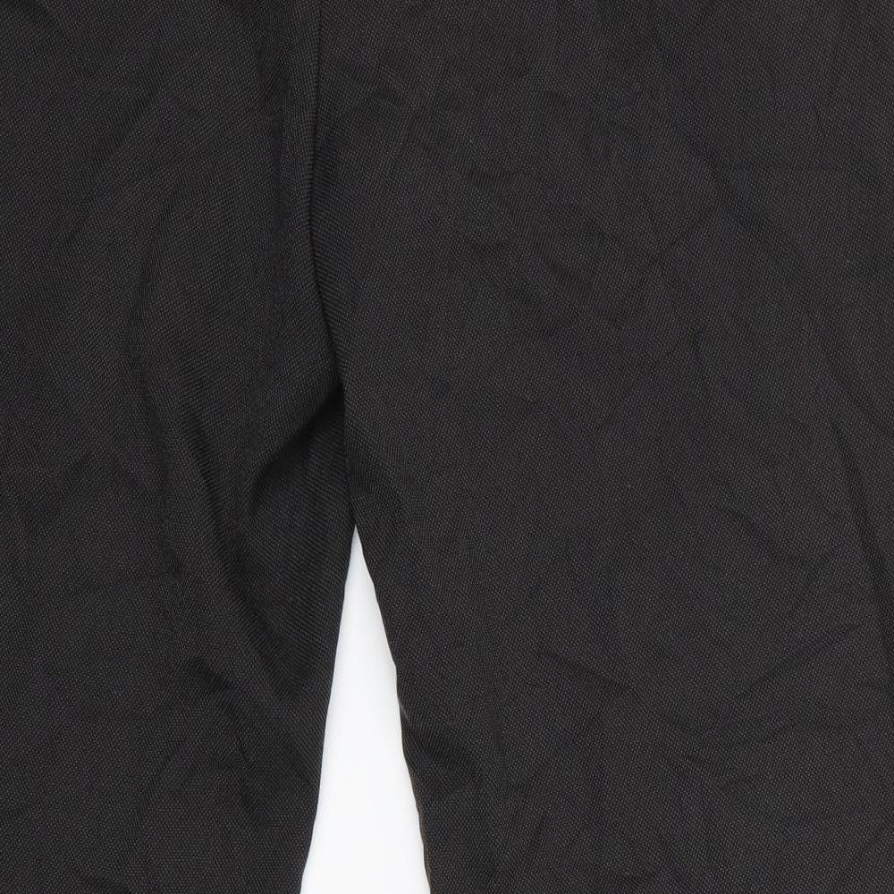 Brand and care label for Taylor & Wright men’s green polka dot trousers, size 36, in, 31-inch leg