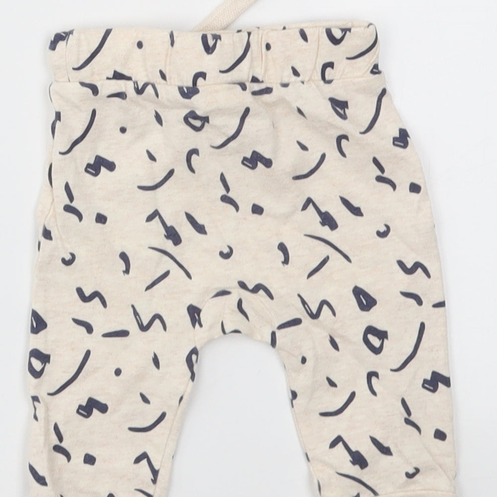 Brand and care label for F&F Baby Ivory Animal Print Capri Leggings, size 3-6, Months