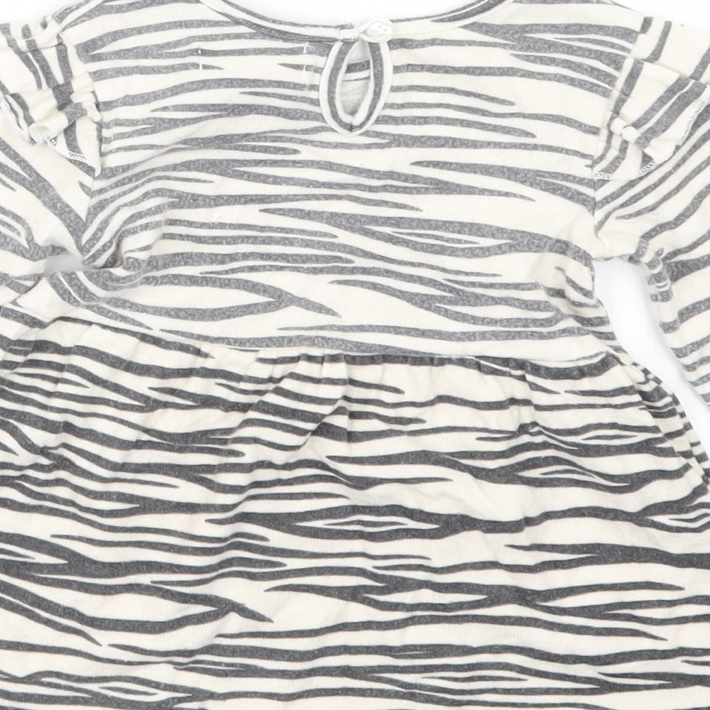 Brand and care label for Primark girls’ beige animal print t-shirt dress, size 12-18, months