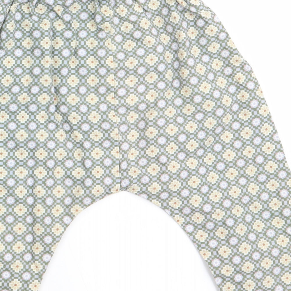Brand and care label for Happyology girls’ green floral cargo trousers