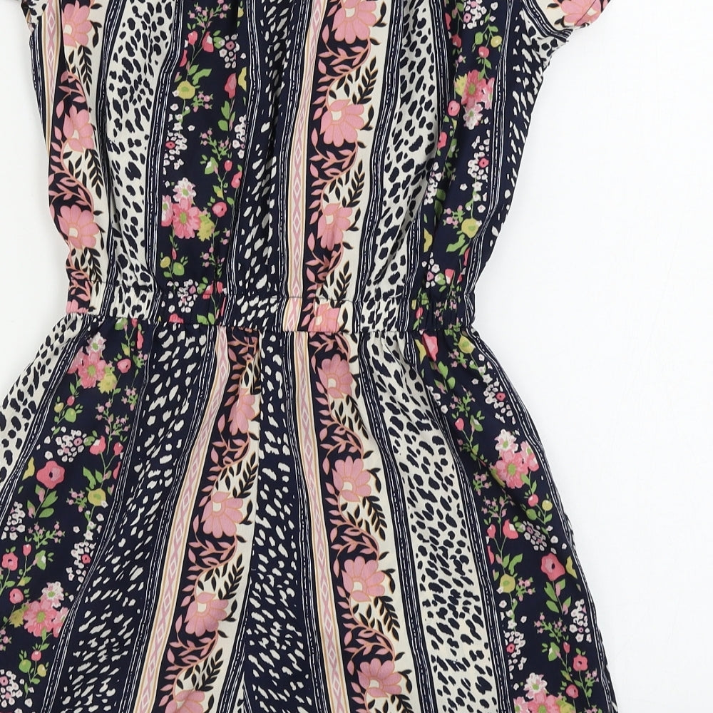 Brand and care label for Atmosphere women’s black floral jumpsuit one-piece, size UK 8