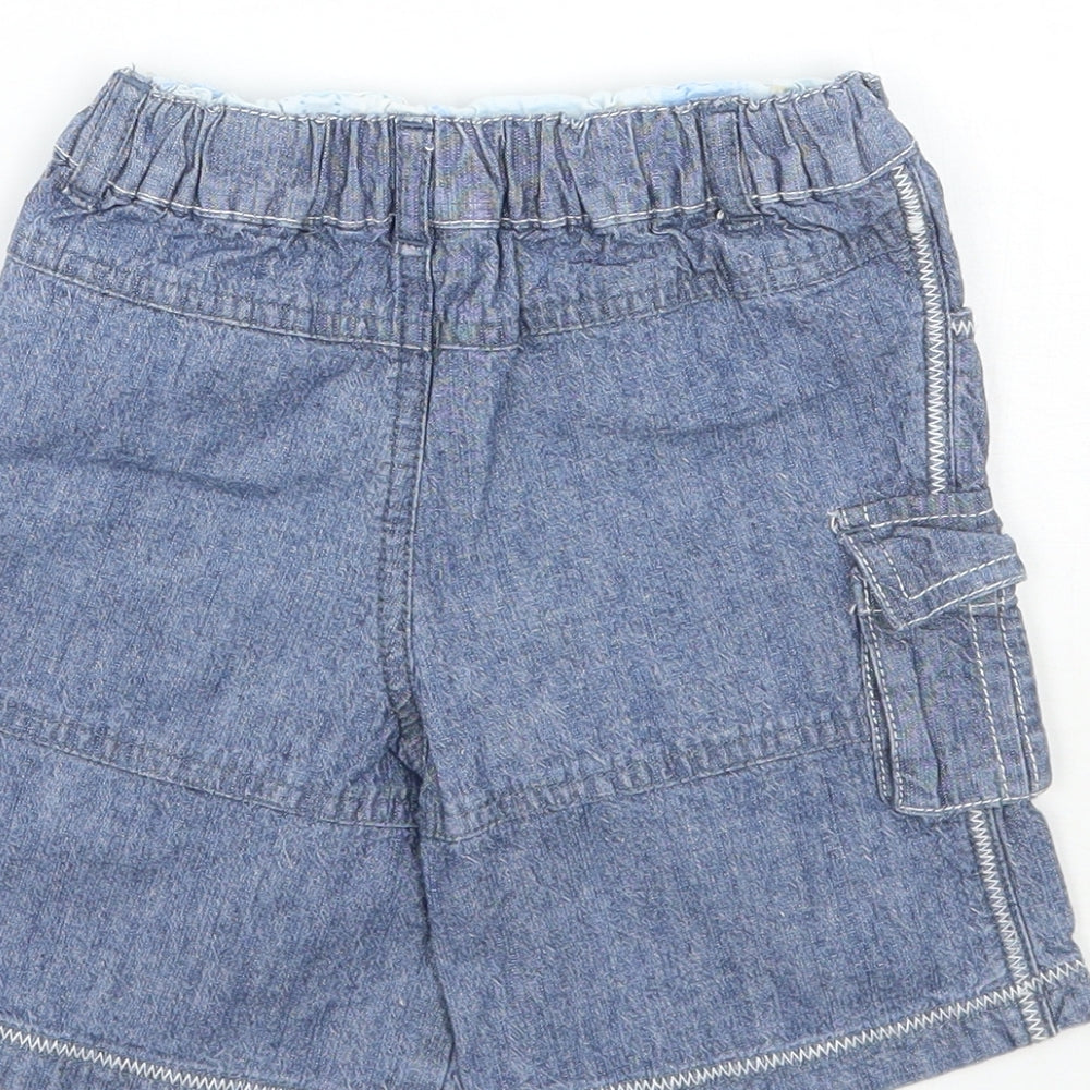 Brand and care label for Mini mode boys’ blue capri jeans, size 9-12, months