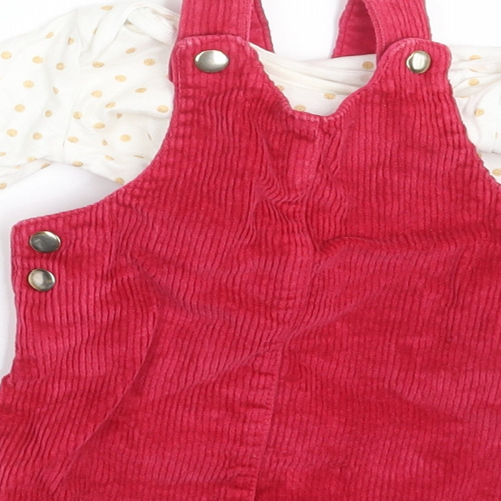 Brand and care label for F&F girls’ pink polka dot corduroy pinafore/dungaree dress, size 3-6, months