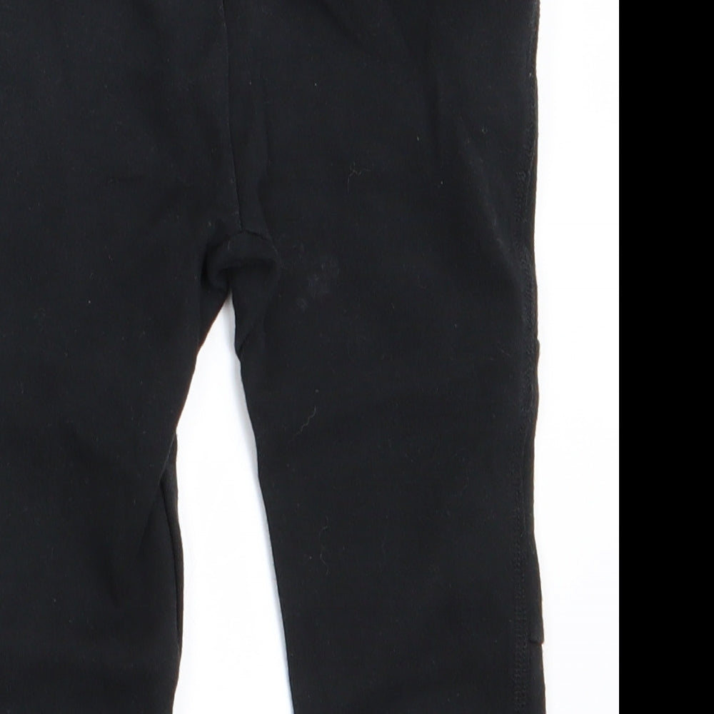 Brand and care label for Gap boys’ black jogger trousers, size 18-24, months