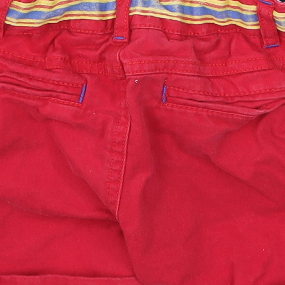 Brand and care label for Monsoon boys’ red cropped trousers, size 12-18, months