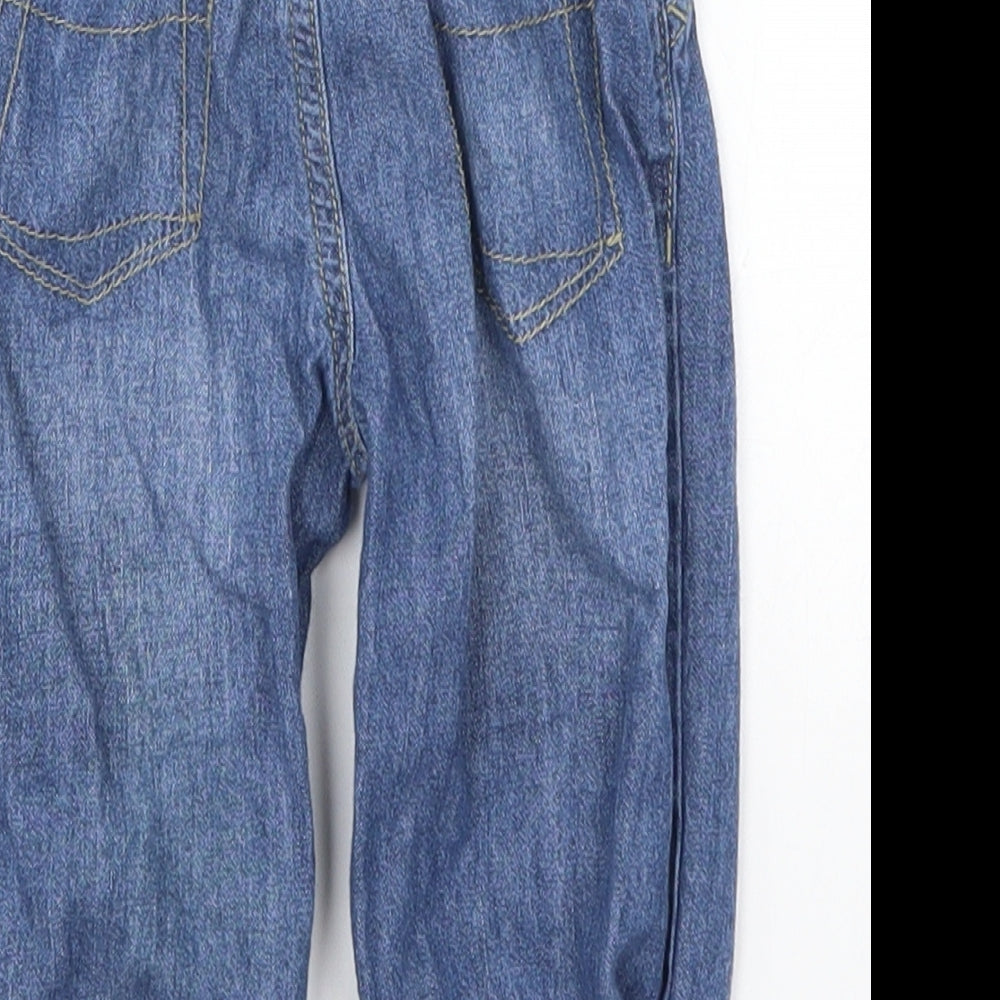 Brand and care label for Ladybird girls’ blue denim capri jeans, size 9-12, months