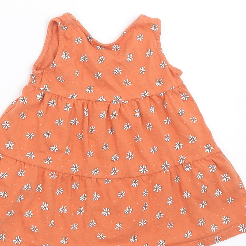 Brand and care label for Primark girls’ orange floral trapeze & swing, size 12-18, months