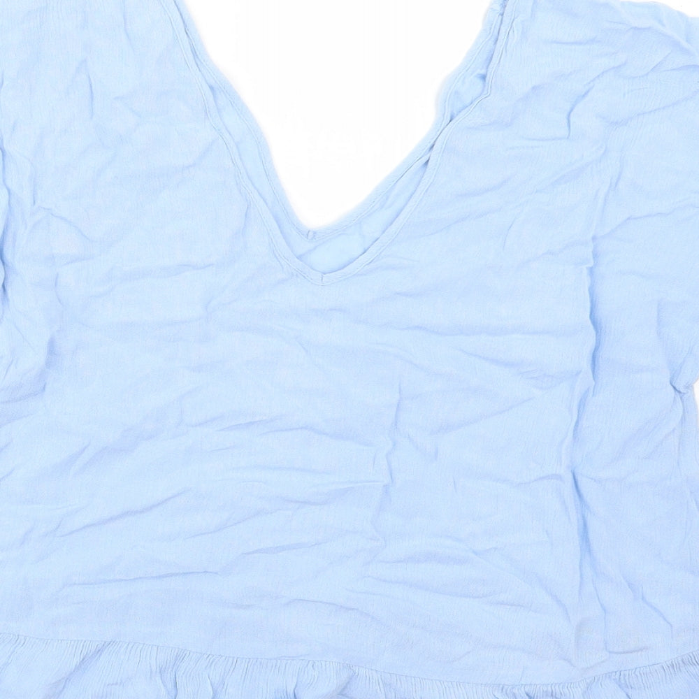 Brand and care label for ASOS women’s blue basic blouse, size UK 10