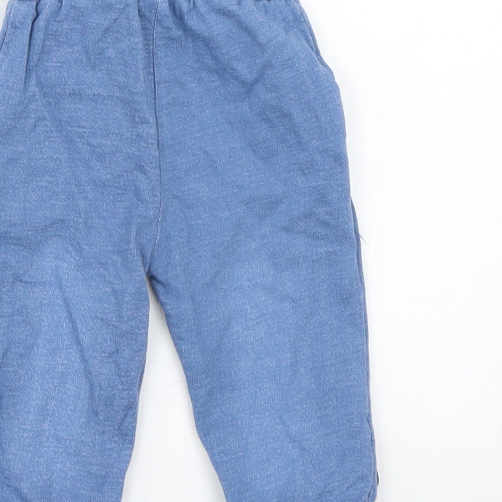Brand and care label for Crafted boys’ blue sweatpants, size 6-9, months