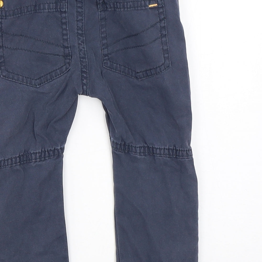 Brand and care label for F&F boys’ blue capri trousers, size 12-18, months