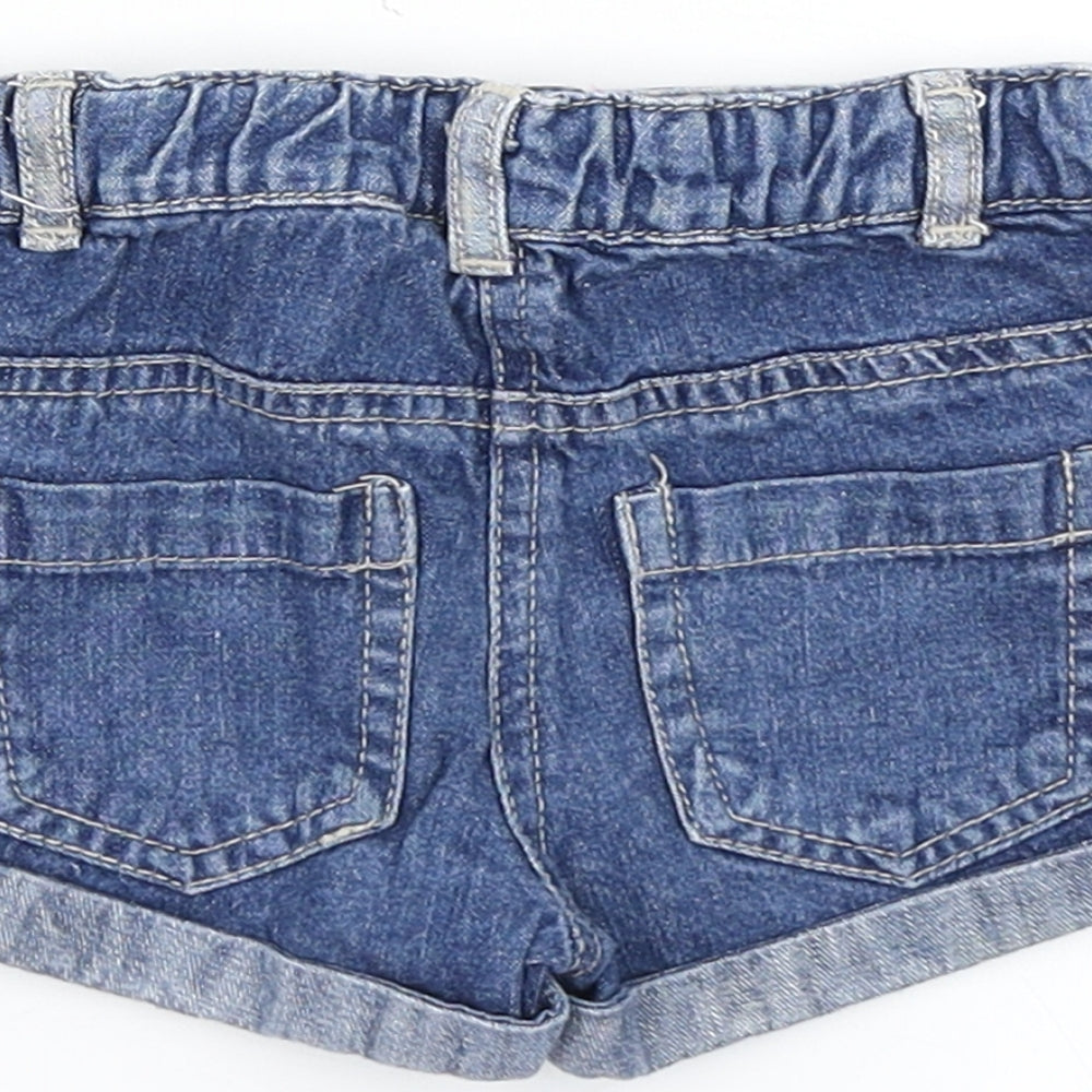 Brand and care label for Young Dimension girls’ blue denim cropped jeans, size 9-12, months