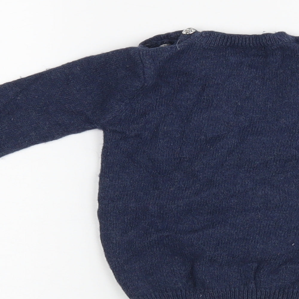 Brand and care label for Next girls’ blue jumper, size 6-9, months