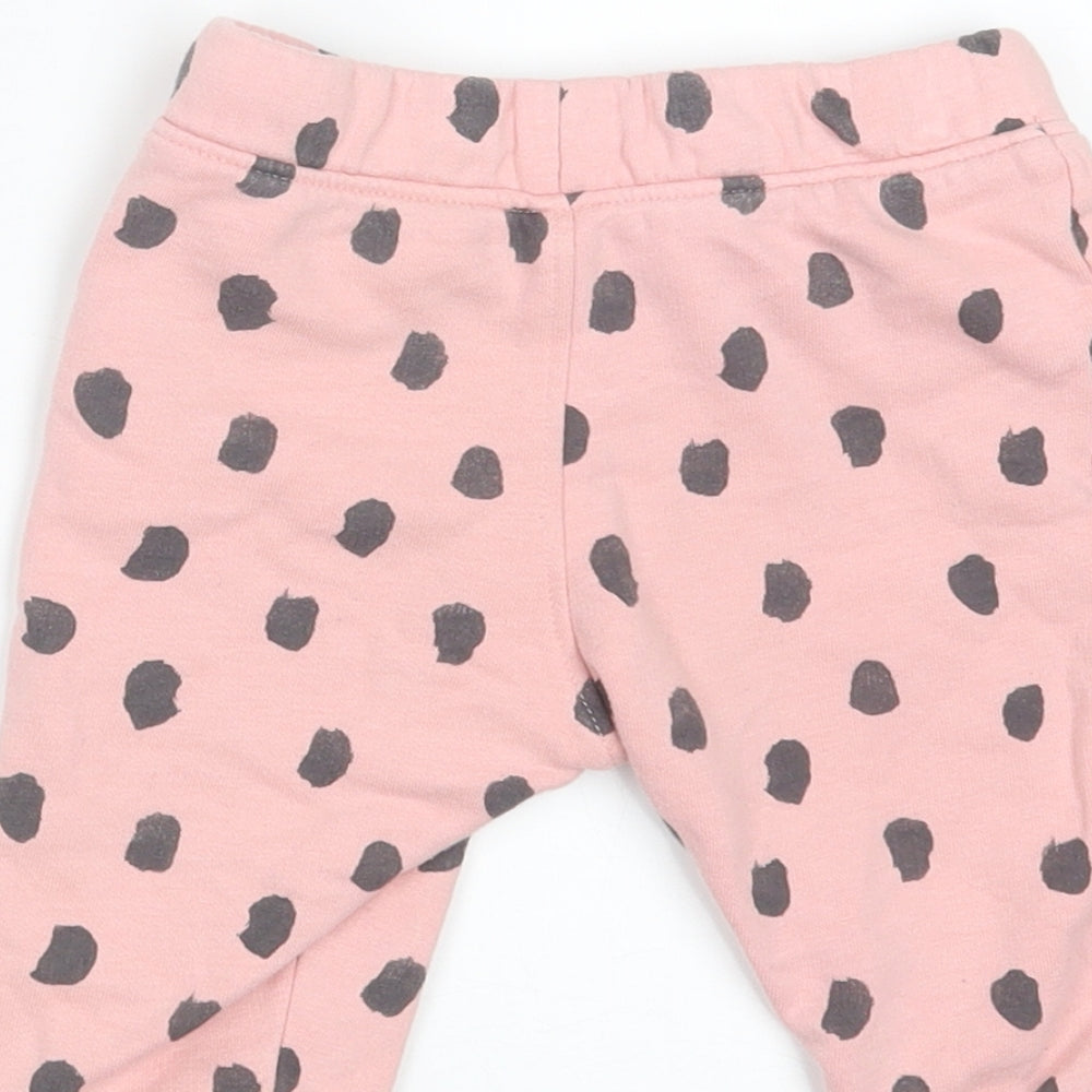 Brand and care label for Marks & Spencer girls’ pink polka dot jogger trousers, size 6-9, months - waist 18in; inside leg 7in