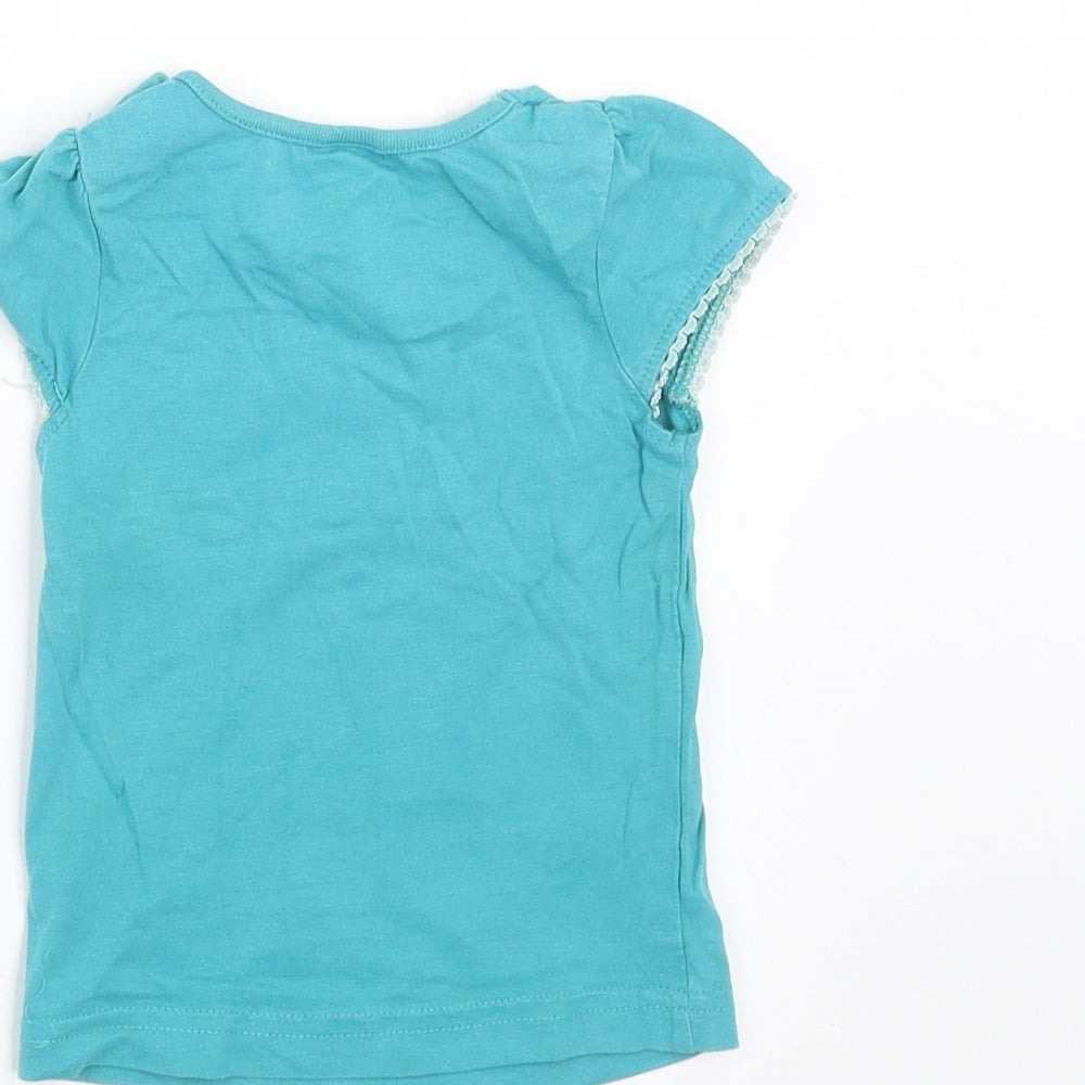 Brand and care label for MINIMODE girls’ blue basic t-shirt, size 6-9, months