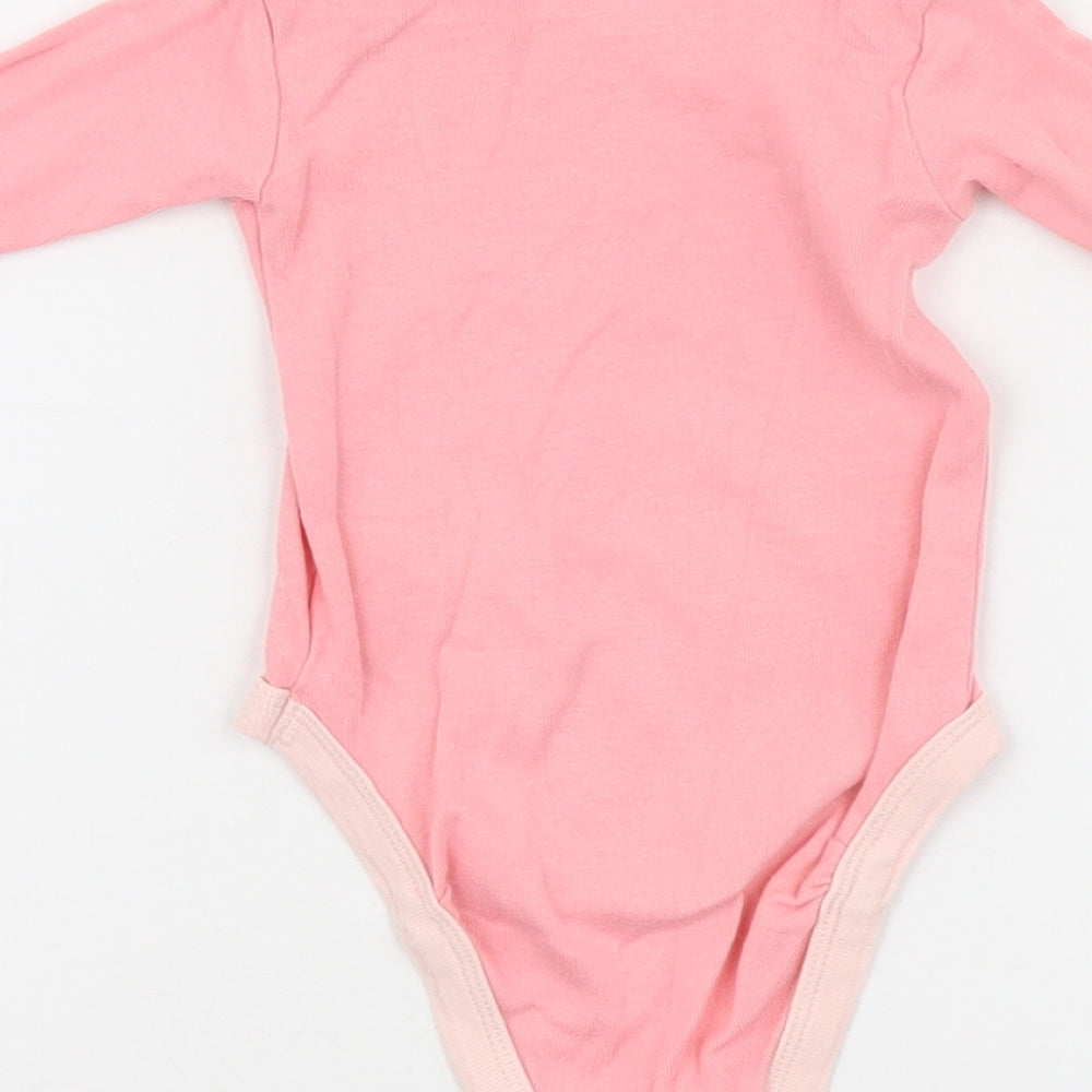 Brand and care label for Looney Toons girls’ pink babygrow one-piece, size 0-3, months