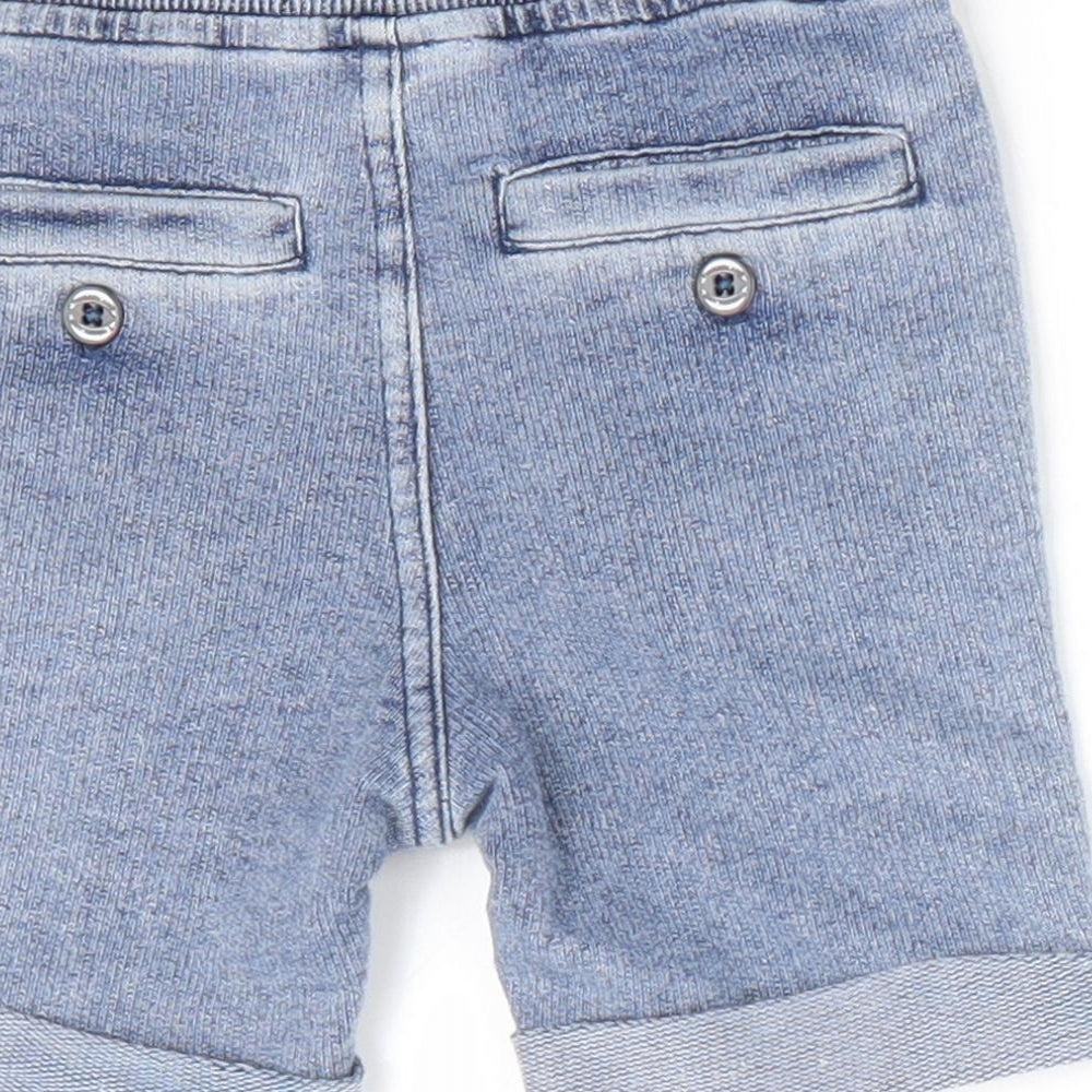 Brand and care label for Timberland boys’ blue jogger jeans, size 6-9, months