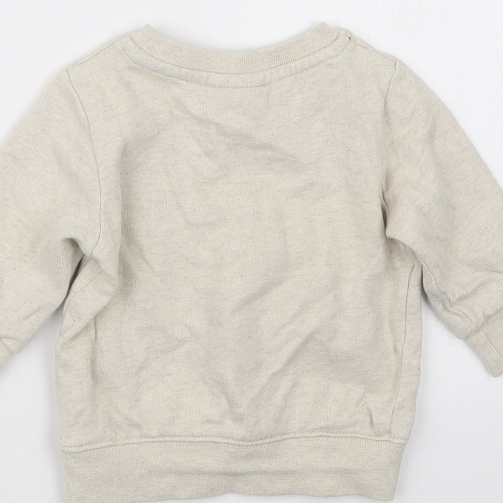 Brand and care label for Next boys’ beige jumper, size 3-6, months