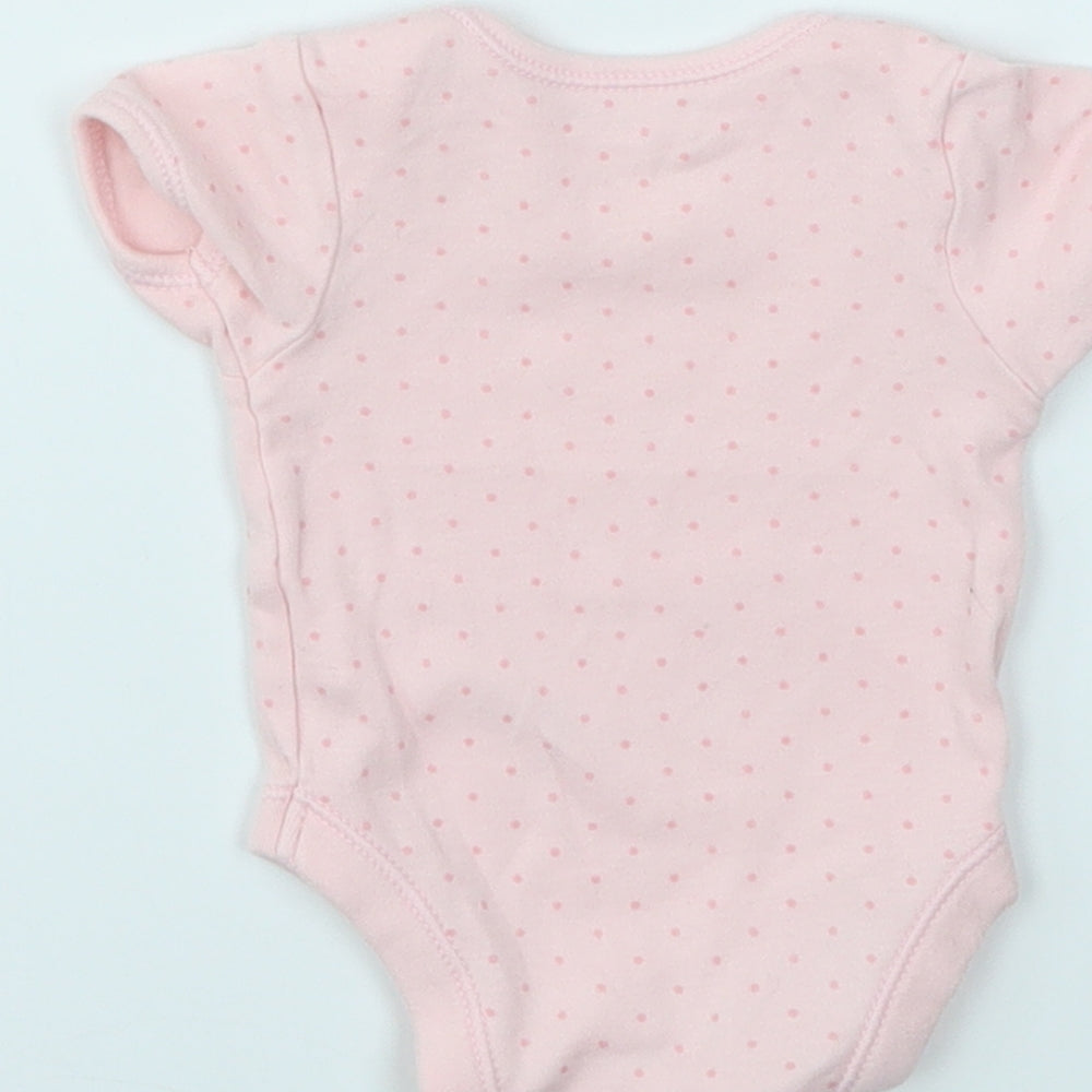 Brand and care label for George girls’ pink spotted babygrow one-piece size newborn