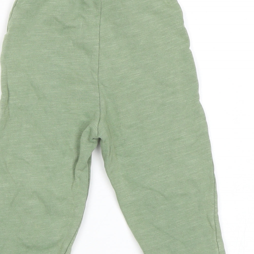 Brand and care label for Matalan Baby Green sweatpants, size 9, Months