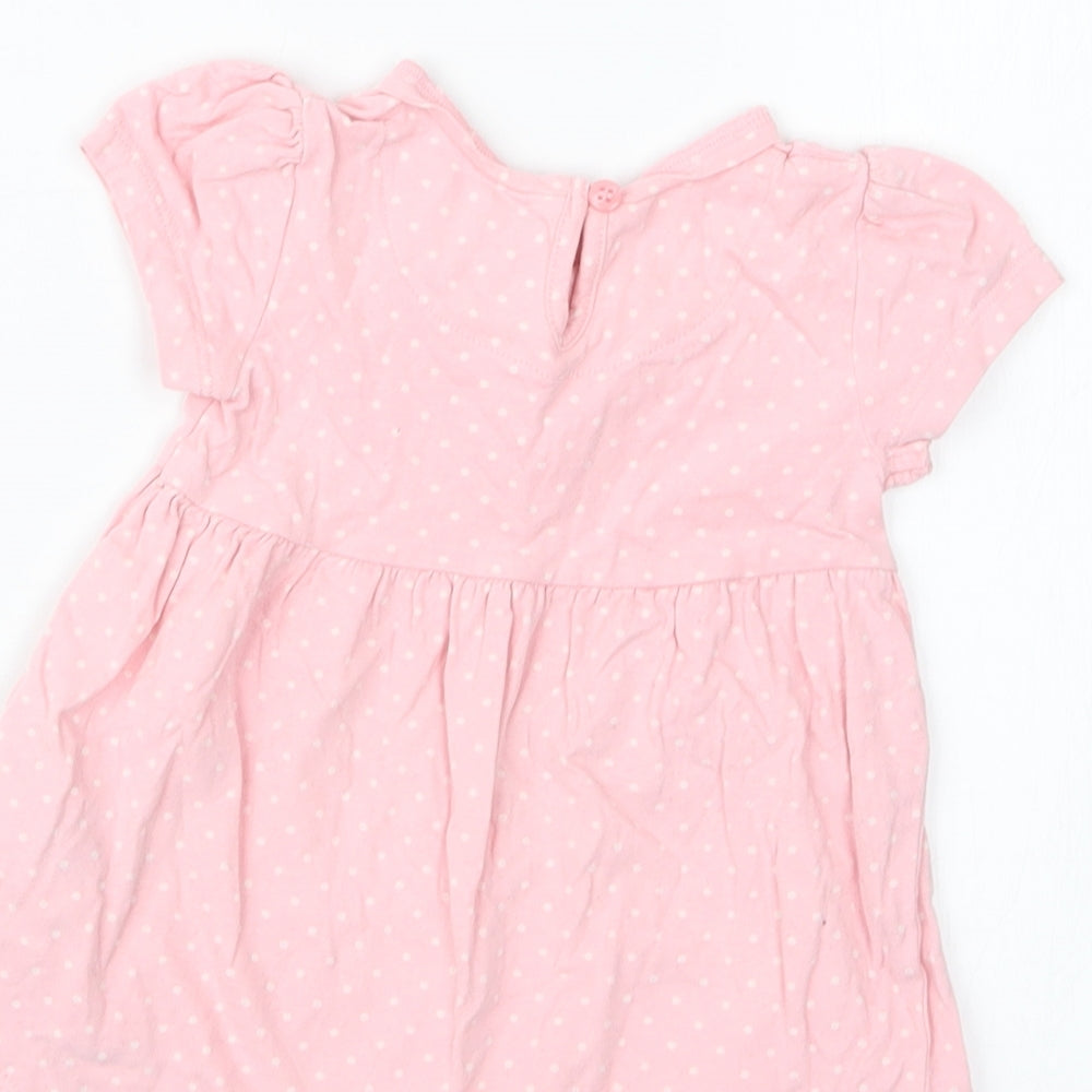 Brand and care label for Mothercare girls’ pink polka dot basic t-shirt, size 3-6, months