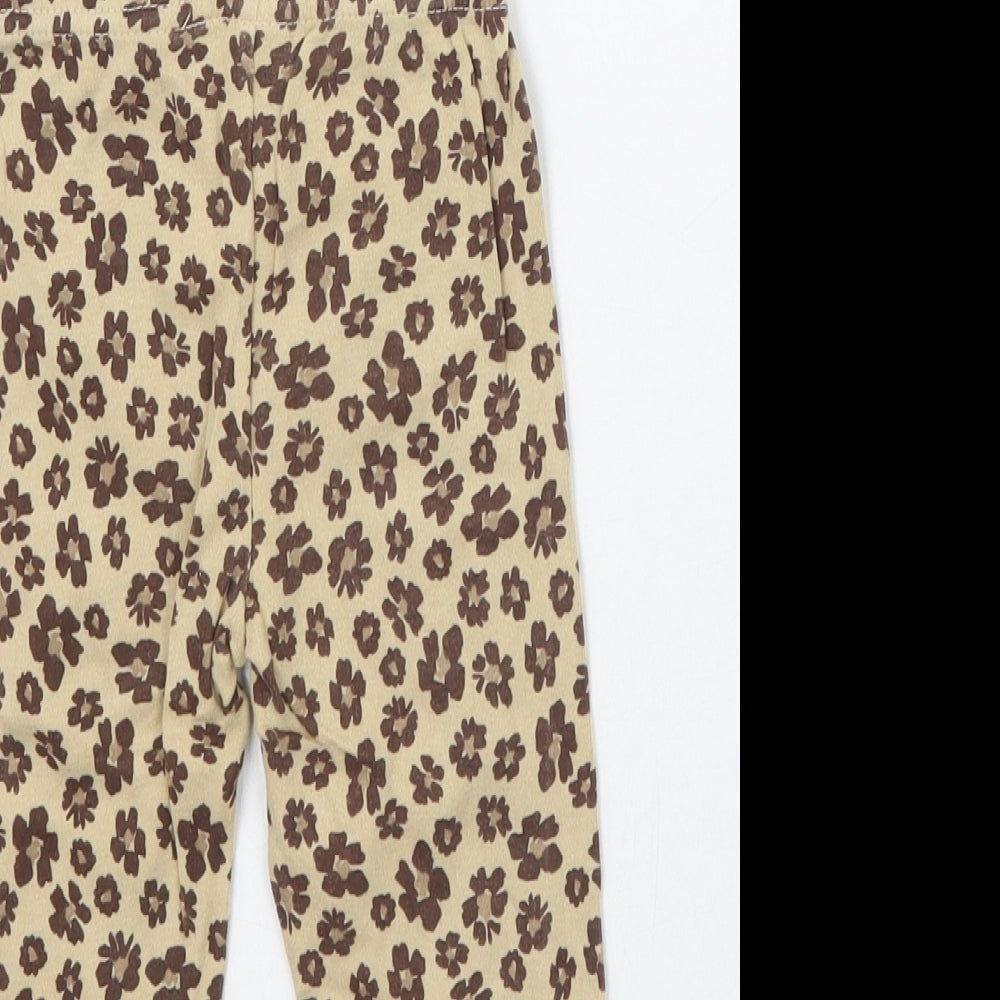 Brand and care label for Carters girls’ brown animal print capri leggings, size 6-9, months