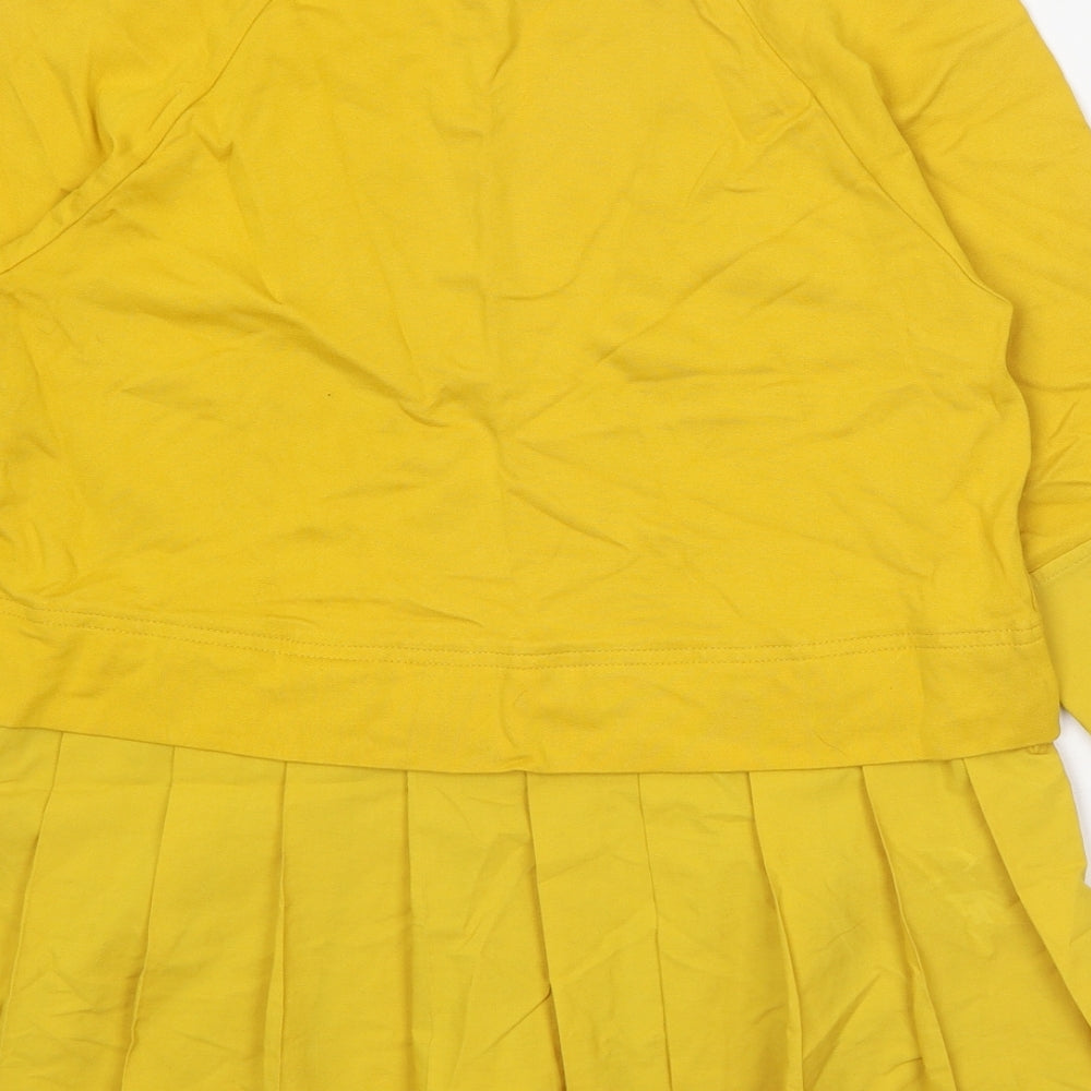 Brand and care label for COS women’s yellow viscose basic blouse, size XS, round neck
