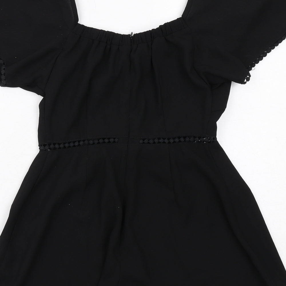 Brand and care label for In the Style women’s black polyester playsuit one-piece, size UK 6, zip