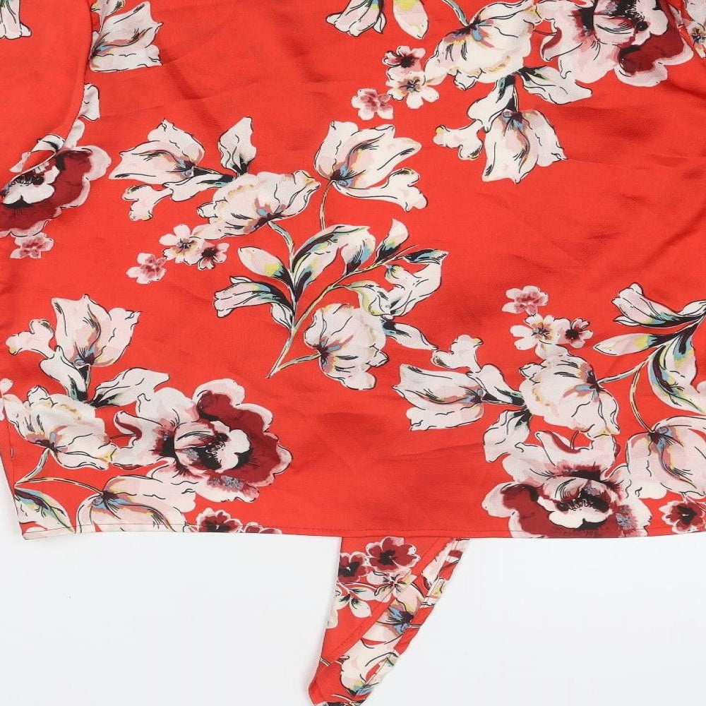 Brand and care label for Missguided women’s red floral polyester basic blouse, size UK 10, v-neck - tie front
