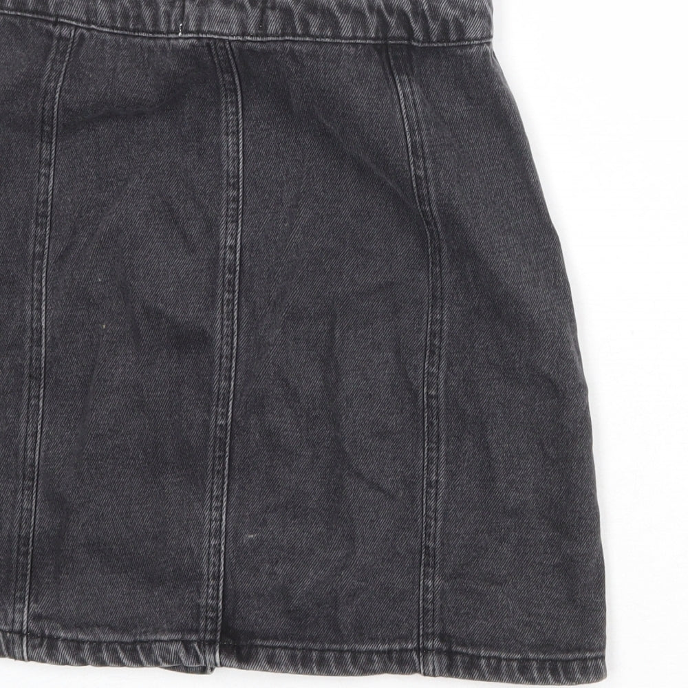 Brand and care label for Miss Selfridge women’s black polyester a-line skirt, size UK 8, button