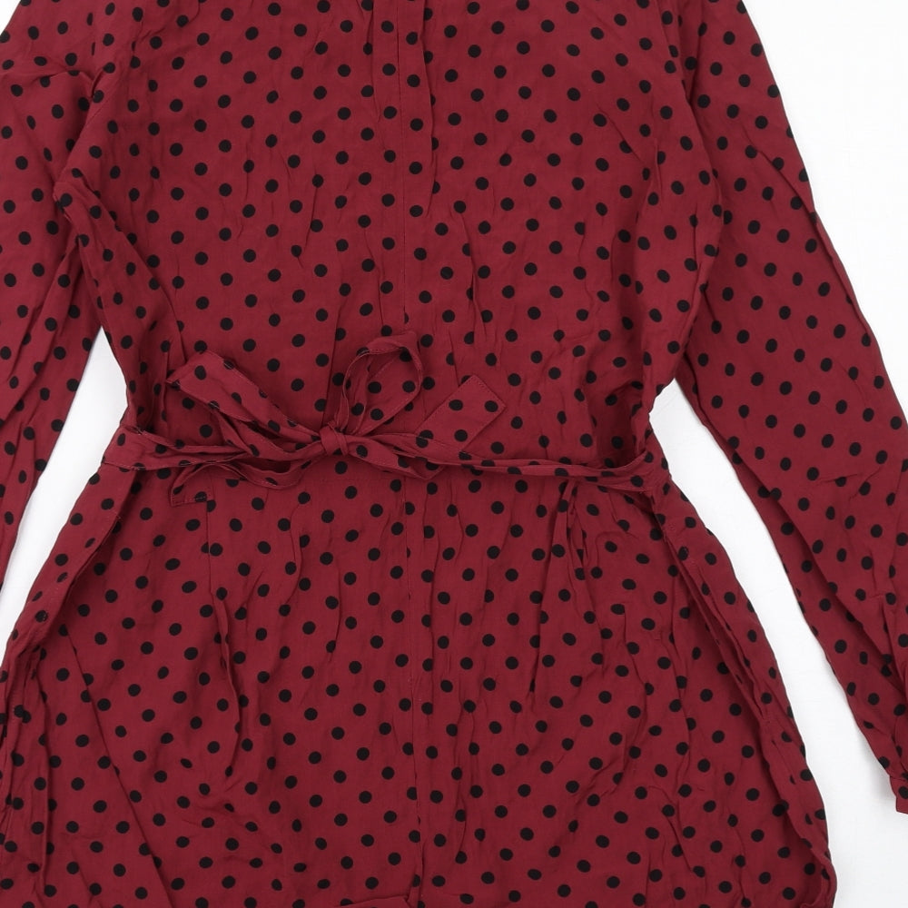 Brand and care label for ASOS women’s red polka dot viscose playsuit one-piece, size UK 10, zip