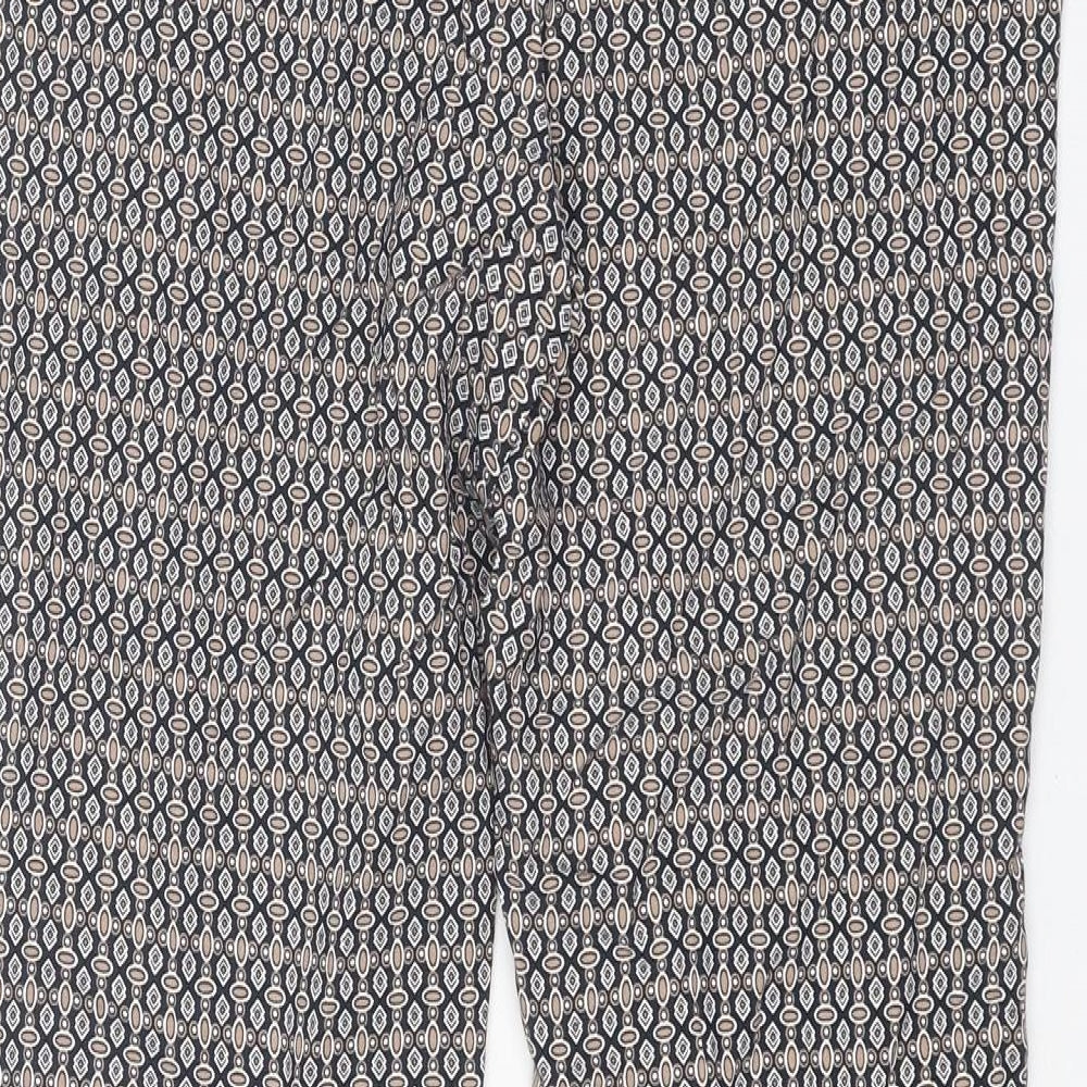 Brand and care label for Dunnes women’s multicoloured geometric viscose trousers, size UK 10, regular zip