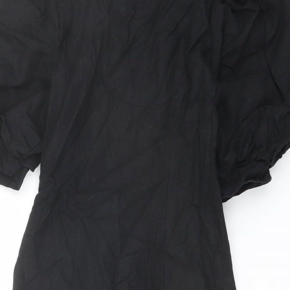 Brand and care label for ASOS women’s black polyester jacket dress, size UK 6, v-neck button