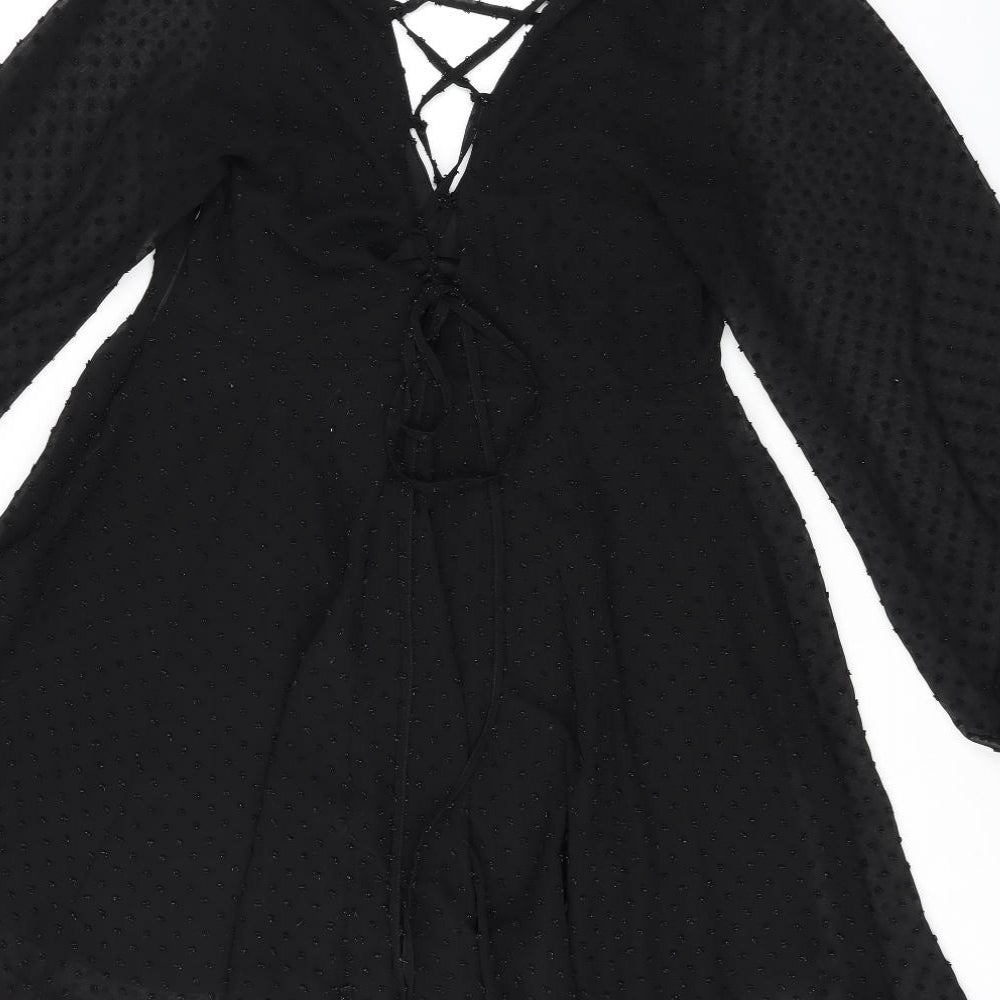 Brand and care label for ASOS women’s black polka dot polyester shift, size UK 10, v-neck zip