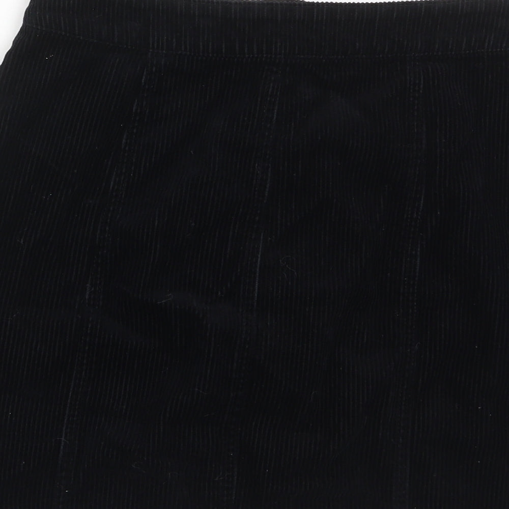 Brand and care label for Miss Selfridge women’s black cotton a-line skirt, size UK 6, button