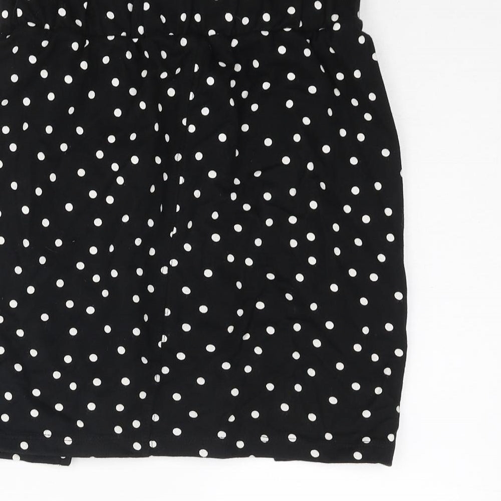 Brand and care label for ASOS women’s black polka dot cotton mini skirt, size UK 8
