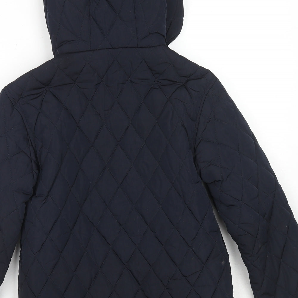 Brand and care label for Mango boys’ blue quilted jacket, size 9, years zip