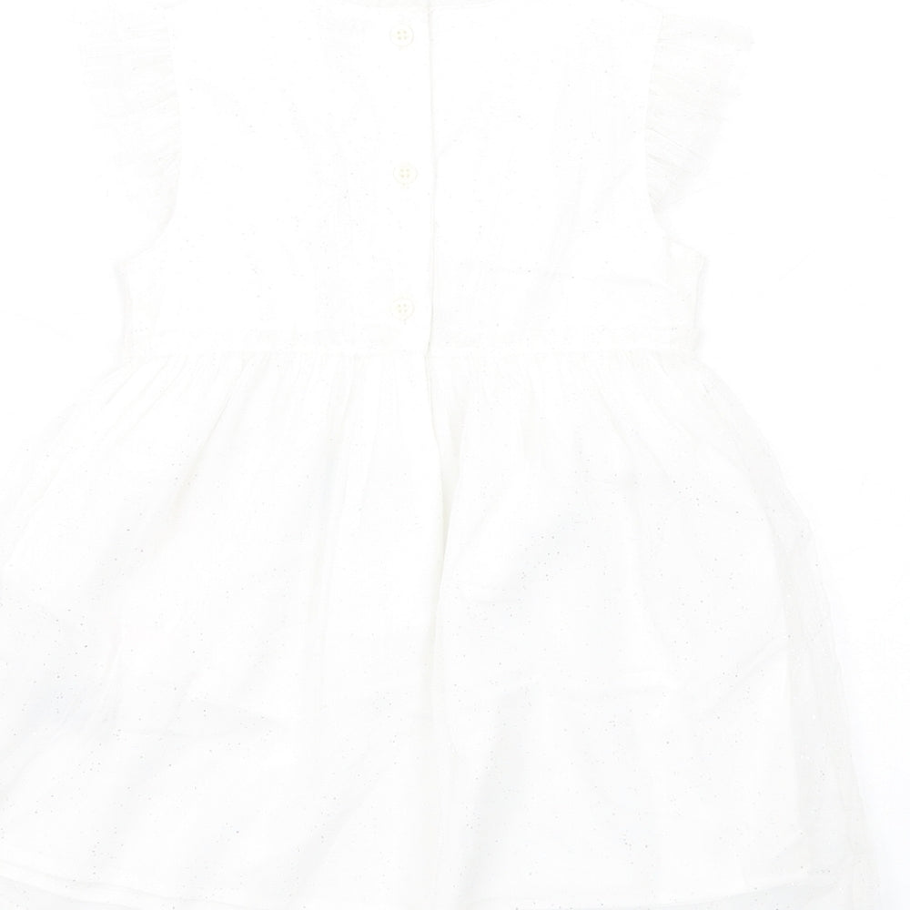 Brand and care label for Marks & Spencer girls’ white pla fibre tutu dress, size 18-24, months round neck button