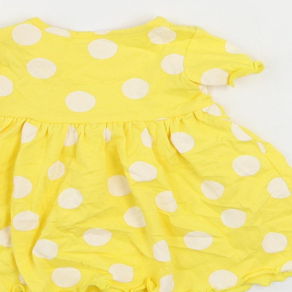 Brand and care label for Marks & Spencer girls’ yellow polka dot cotton a-line, size 3-6, months round neck snap