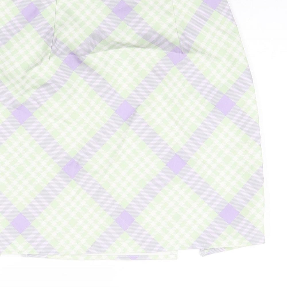 Brand and care label for Missguided women’s green check polyester mini skirt, size UK 10, zip