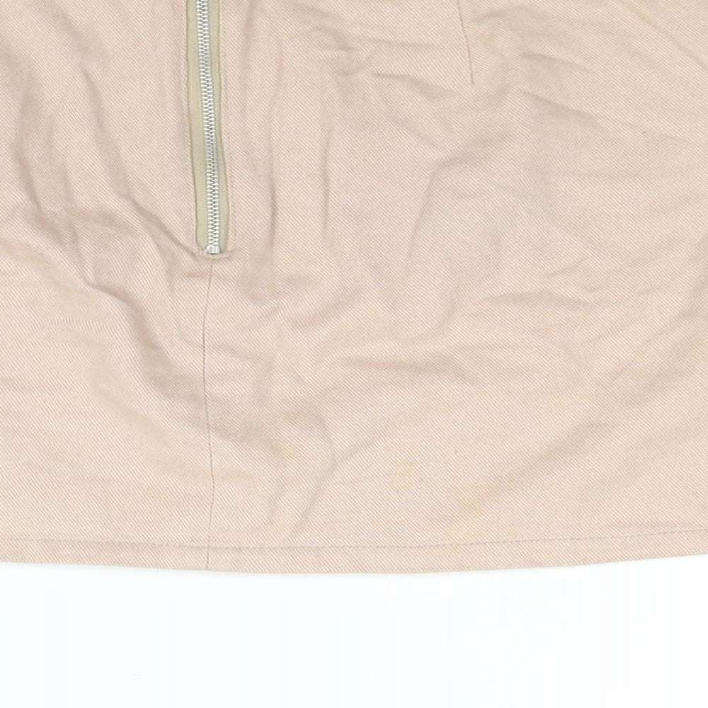 Brand and care label for BDG women’s pink cotton mini skirt, size L, zip