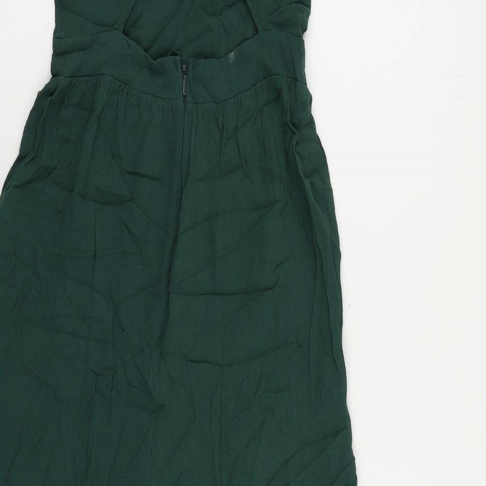 Brand and care label for ASOS women’s green viscose jumpsuit one-piece, size UK 6, 21-inch leg button