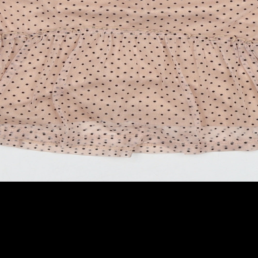 Brand and care label for Next girls’ beige polka dot polyester basic blouse, size 9-12, months round neck button