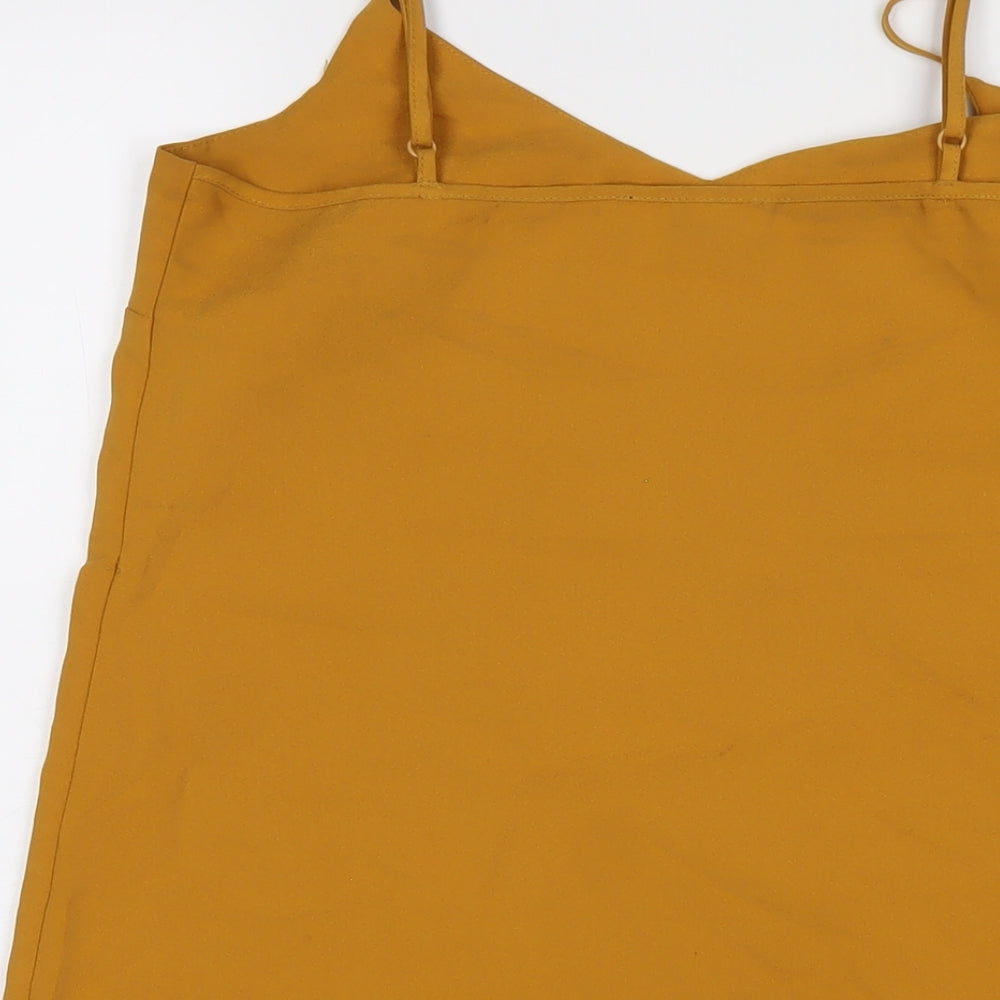 Brand and care label for Missguided women’s yellow polyester slip dress, size UK 10, v-neck pullover